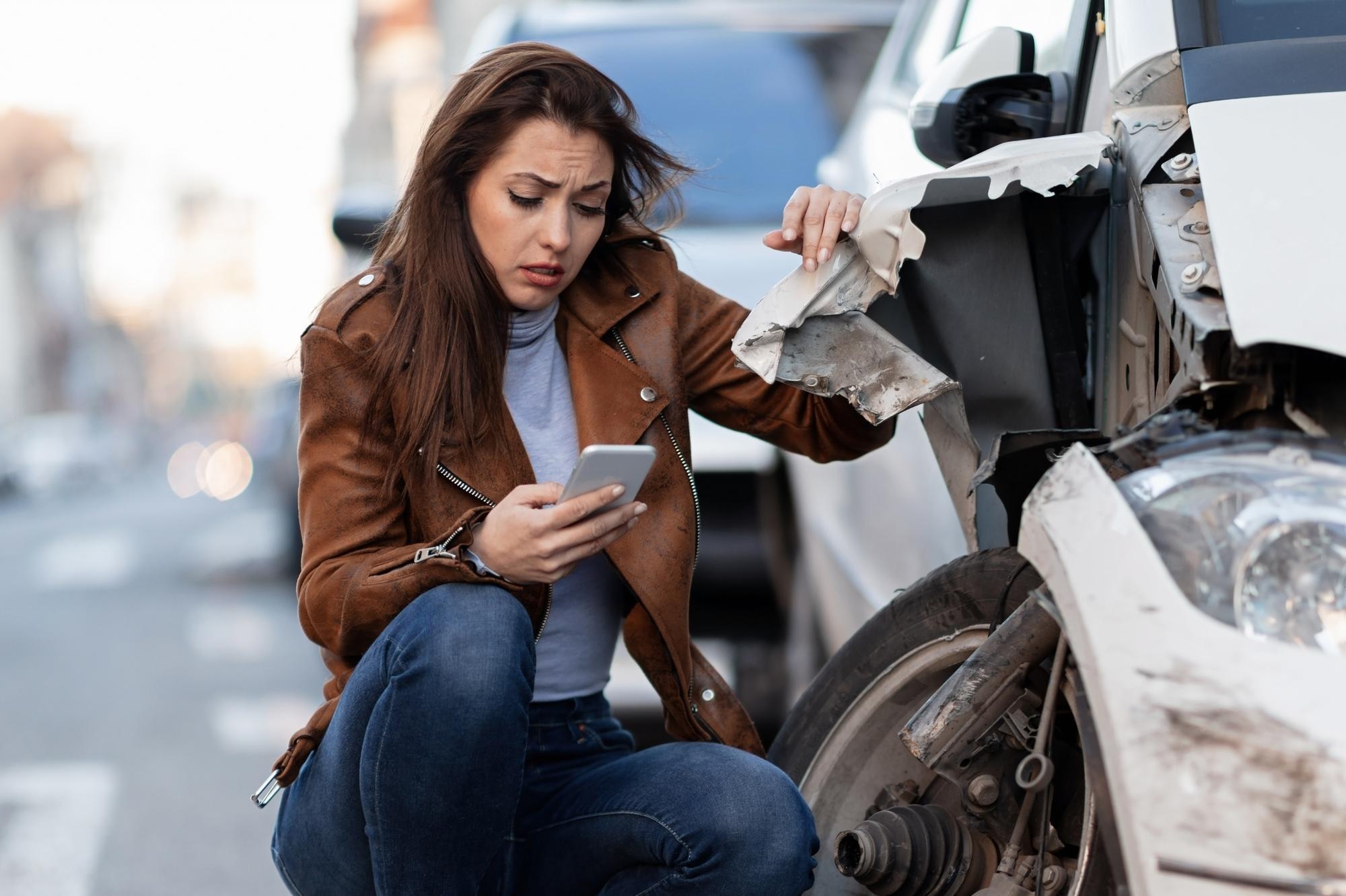 young sad woman text messaging smart after car crash road 637285 1095
